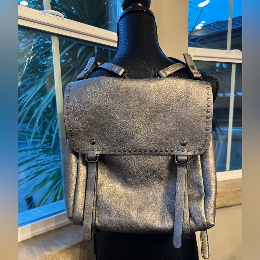 Jen & Co Valerie Flap Metallic Silver Backpack with Grommet Detailing